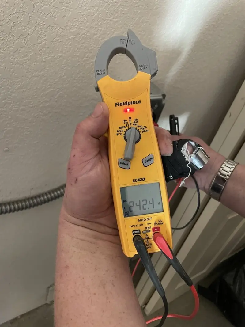 Voltage testing with clamp meter during Aluminum Wiring Replacement in Evans